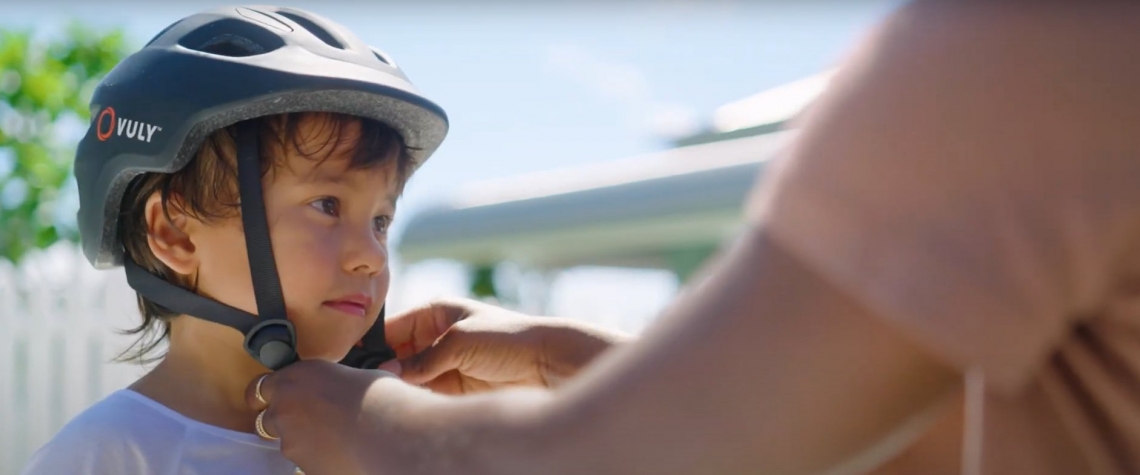Kid putting on bike helmet - Vuly Play.jpg